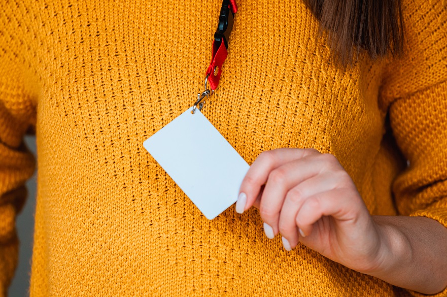 Woman holding a blank name badge
