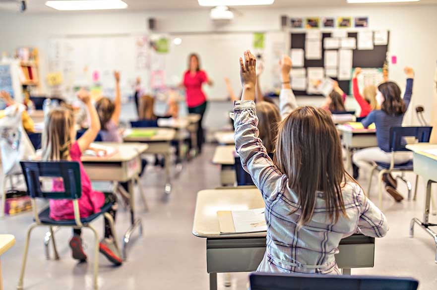 education and school concept little student girl studying at school with hand up