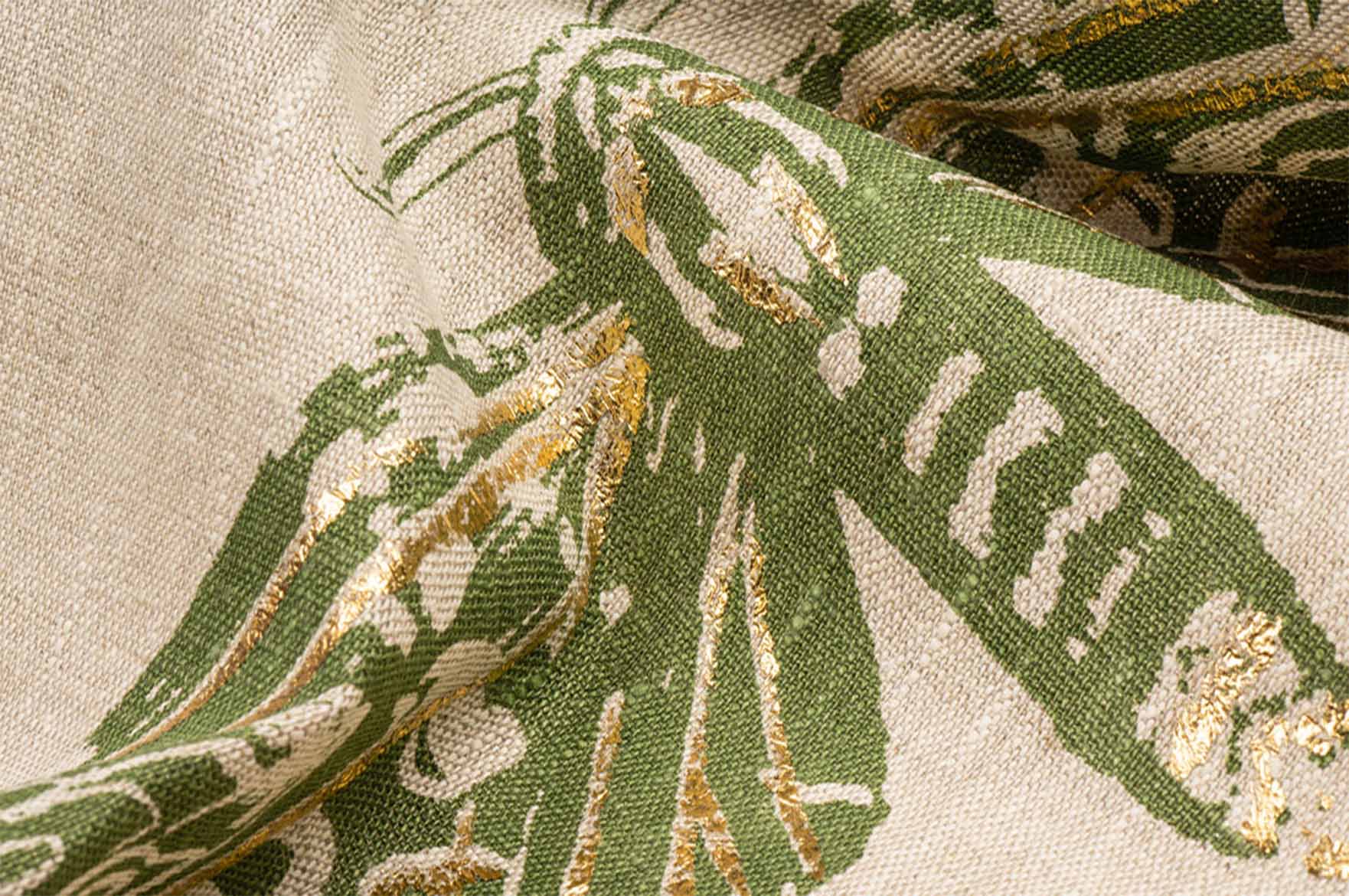 Textile design featuring a green butterfly on a cream fabric