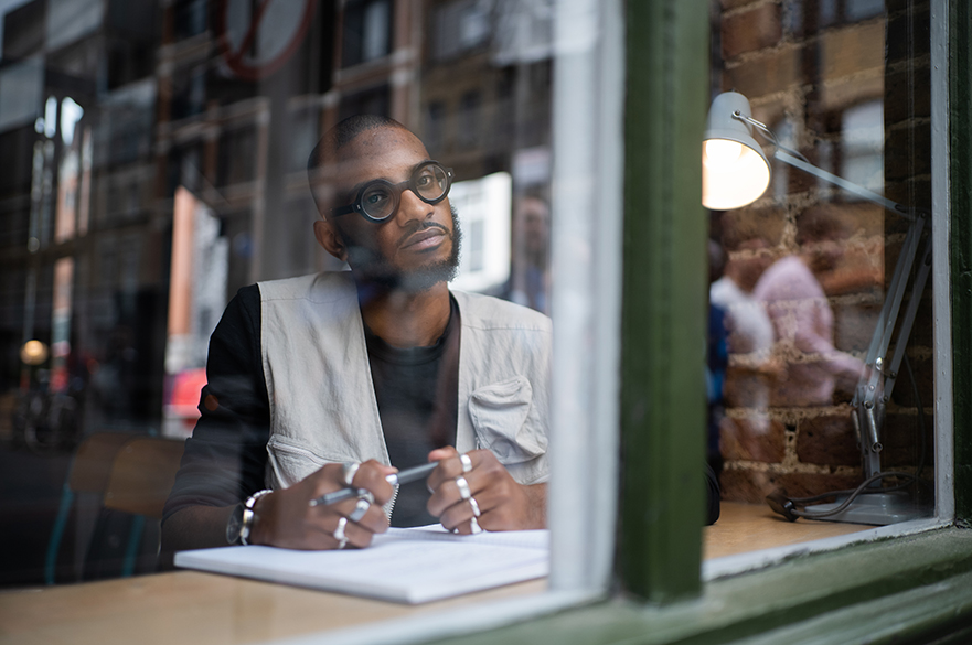 A man sat in a cafe looking out the window.