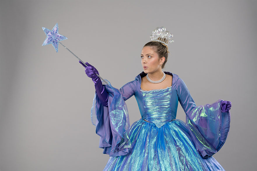 Person wearing a blue ball gown holding a wand