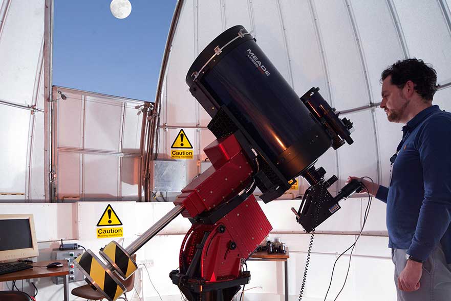 man using telescope