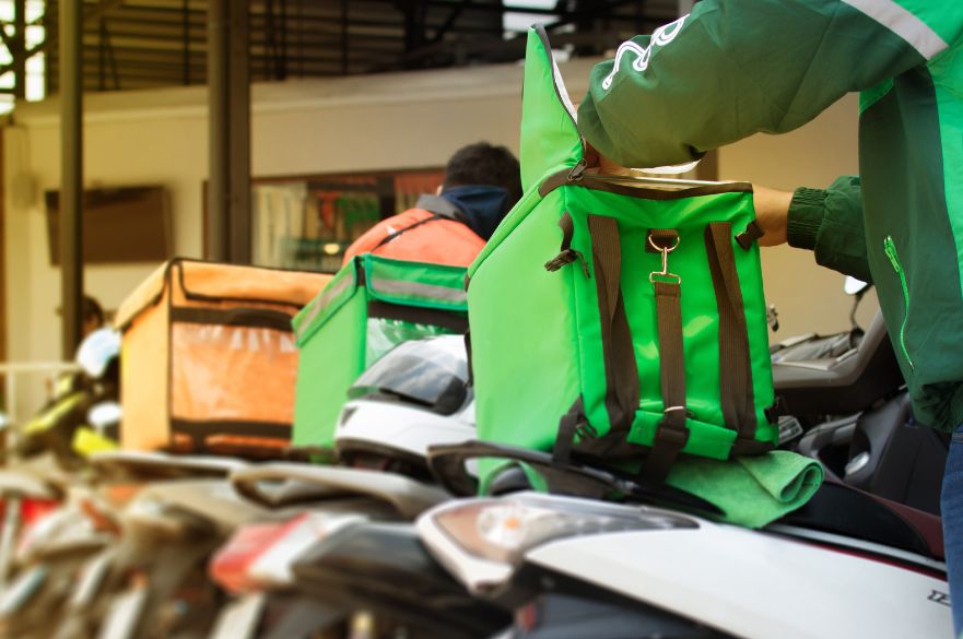 Food delivery drivers with bags on bikes in the informal economy