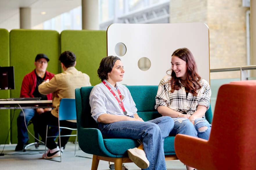 Staff member and student sat in SSC Newton Building