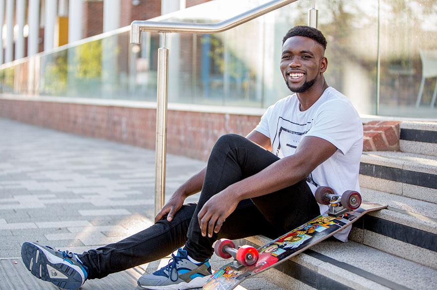 student-on-campus-with-skateboard