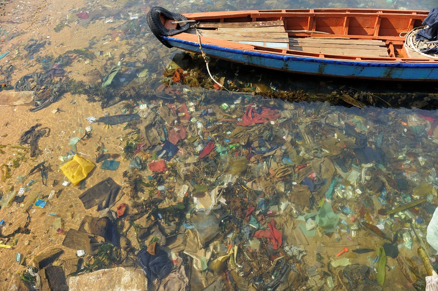 Plastic at the bottom of the ocean with boat