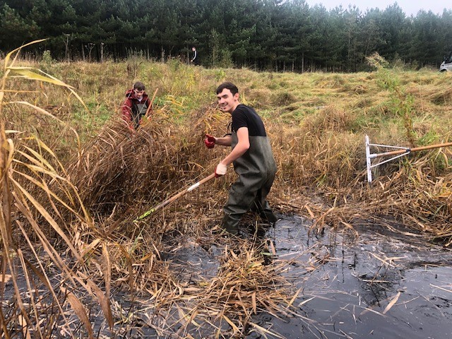 Student working in pond 