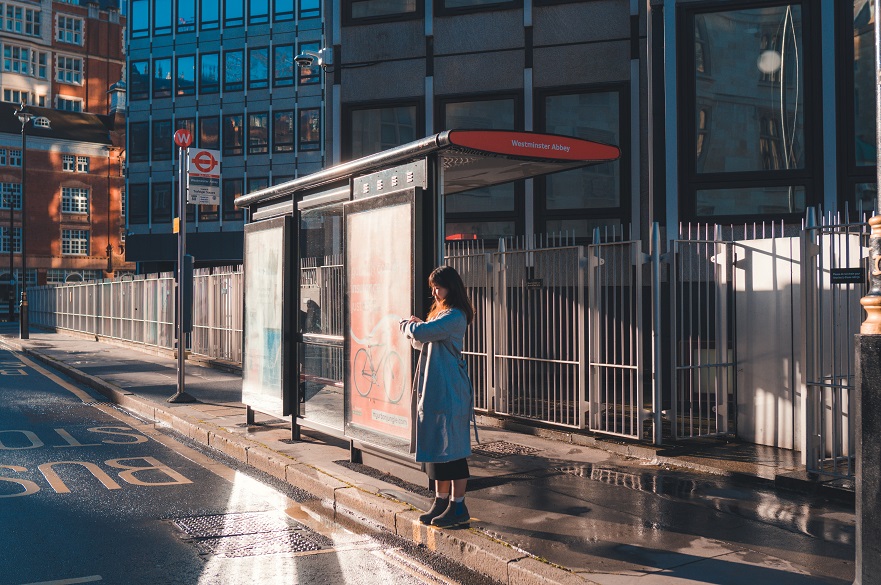 Woman waiting at a bus stop