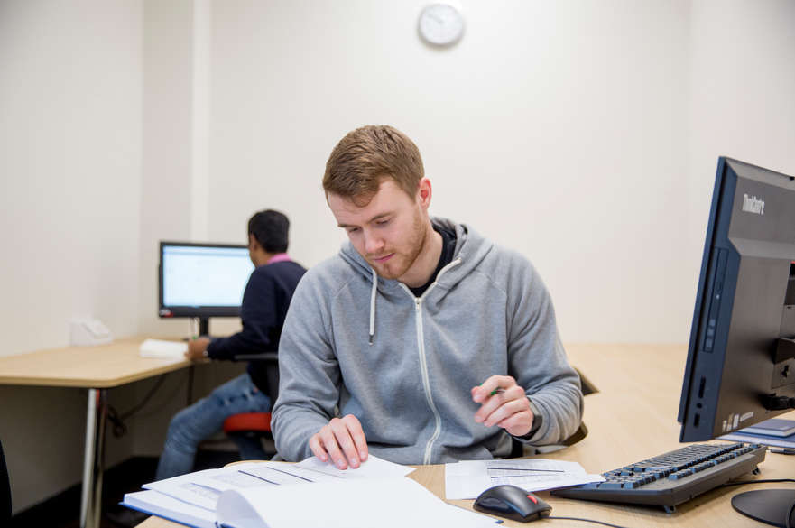 Student reading at desk