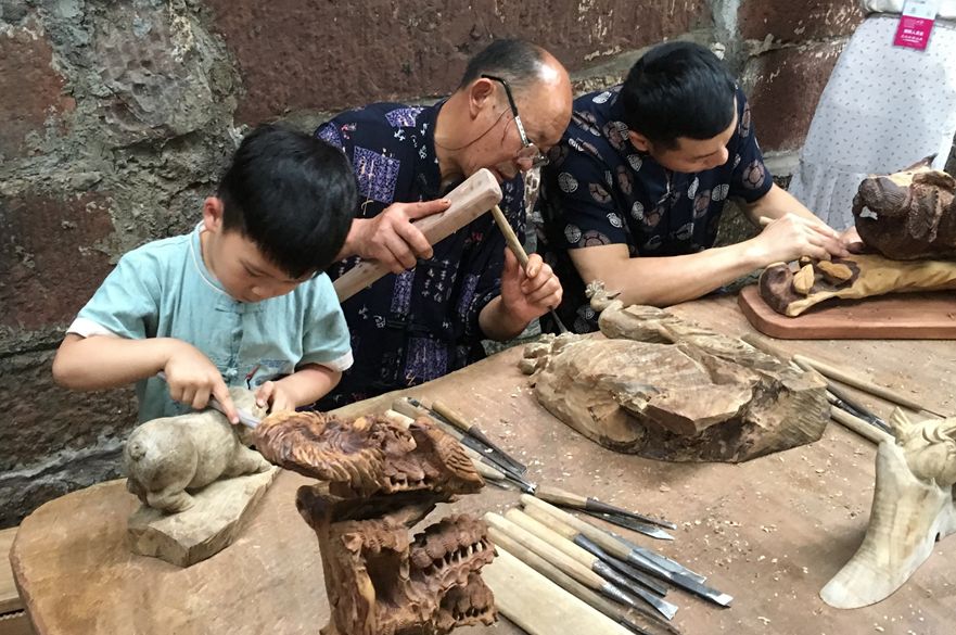 Chinese people carving wood
