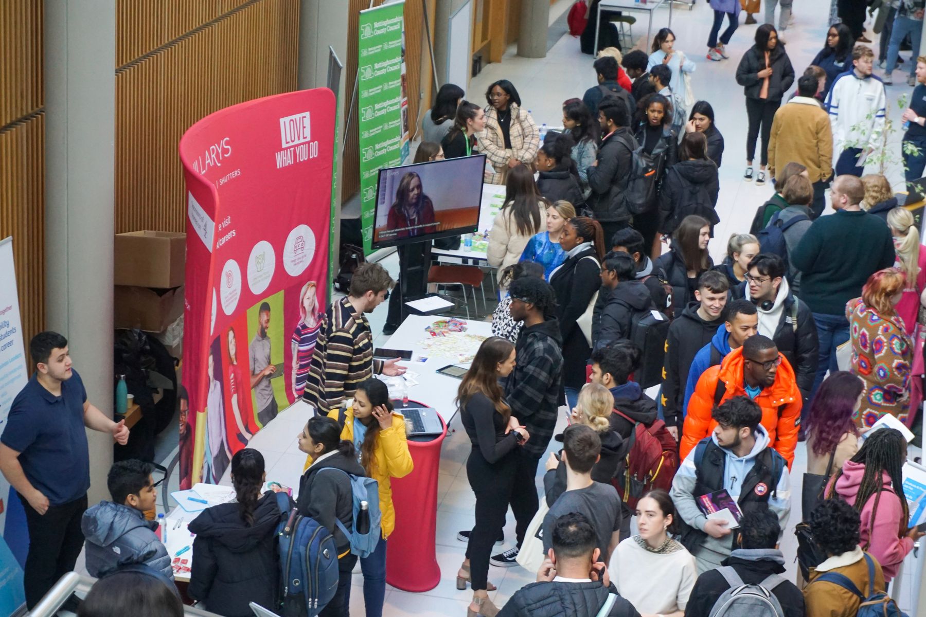 Students speaking to employers at job fair