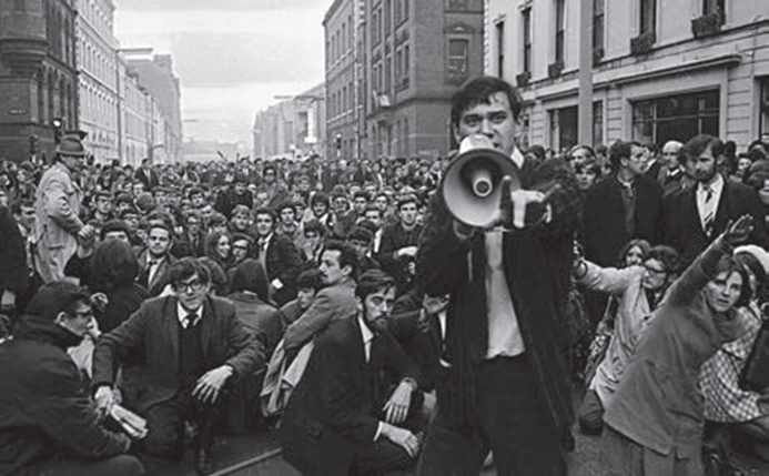 Man speaks on a megaphone during a protest