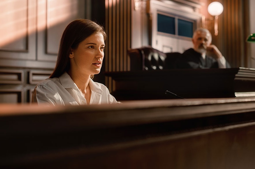 Woman in the witness box in a courtroom