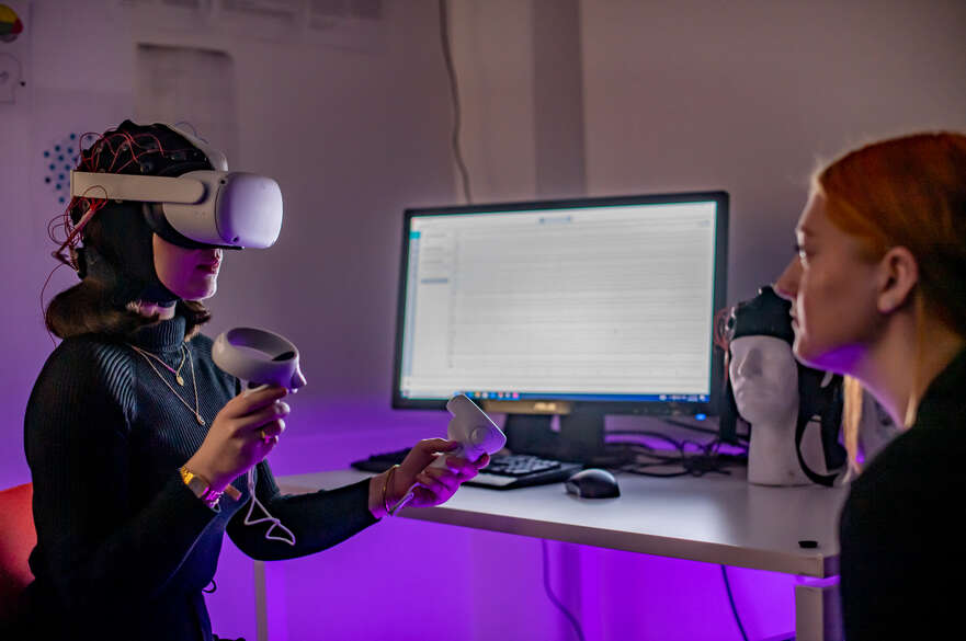 Photo showing a Psychology student using a VR headset