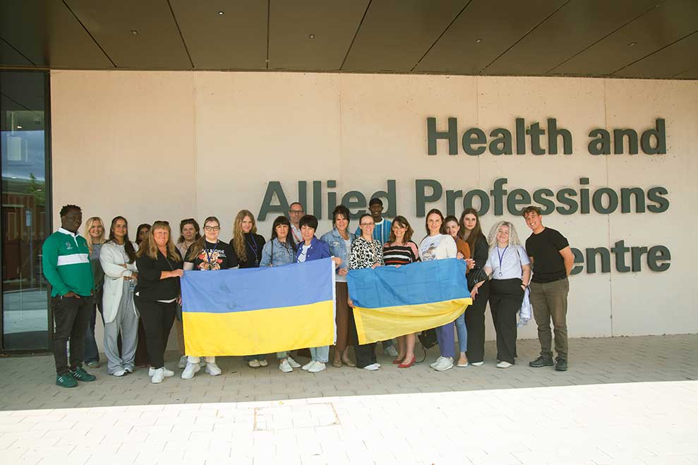 Ukranian nursing delegates in front of the HAP building with Ukranian flag