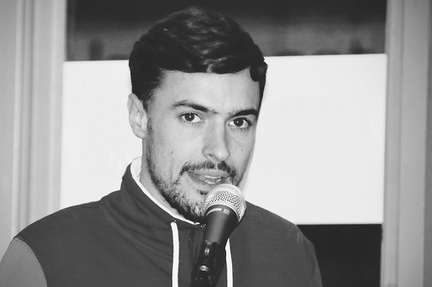 A young male speaking into a microphone