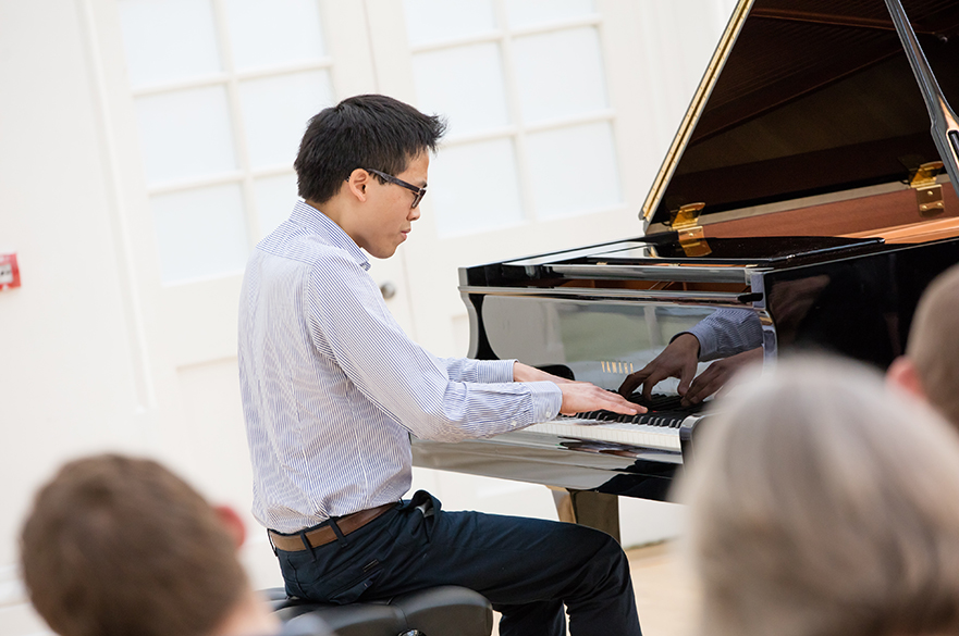 A male student playing the piano.