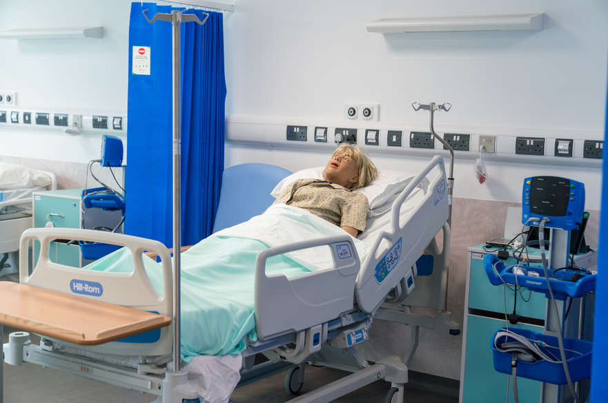 Hospital bed in mock ward setting