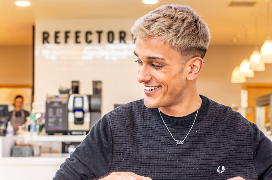 A student smiling at the Clifton Refectory