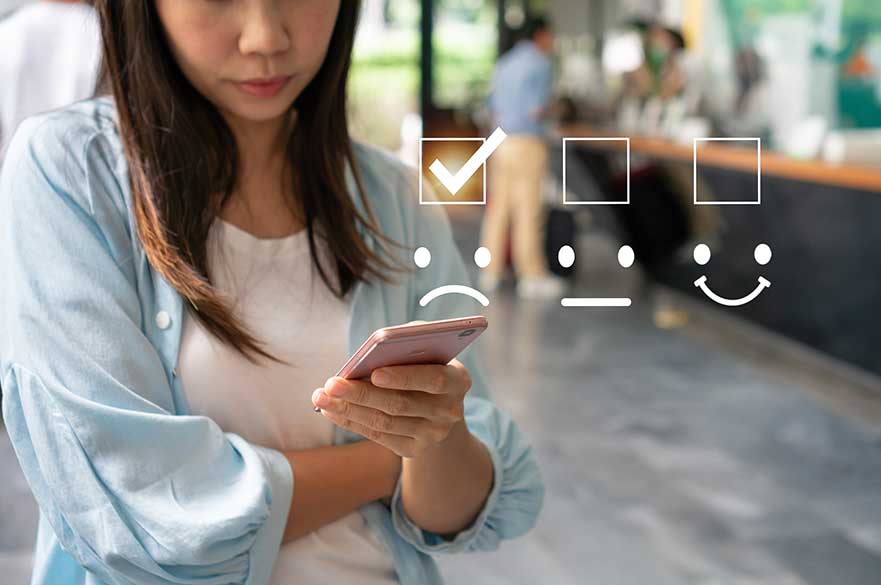 Lady with her phone giving a bad rating online