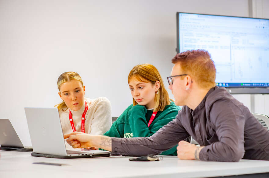 discussing work on laptop