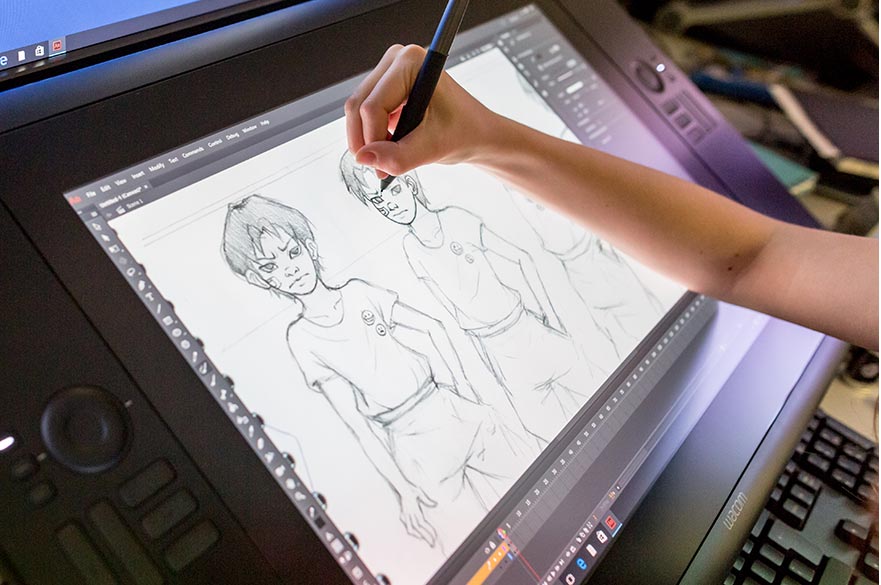wacom tablet with image of a figure from two different angles and a hand holding a stylus 