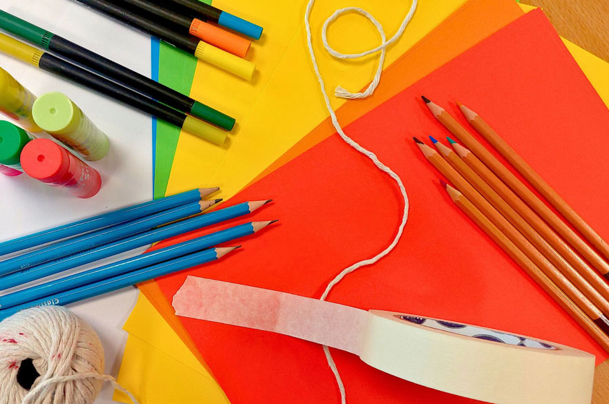 Brightly coloured pens, paper and other craft materials.
