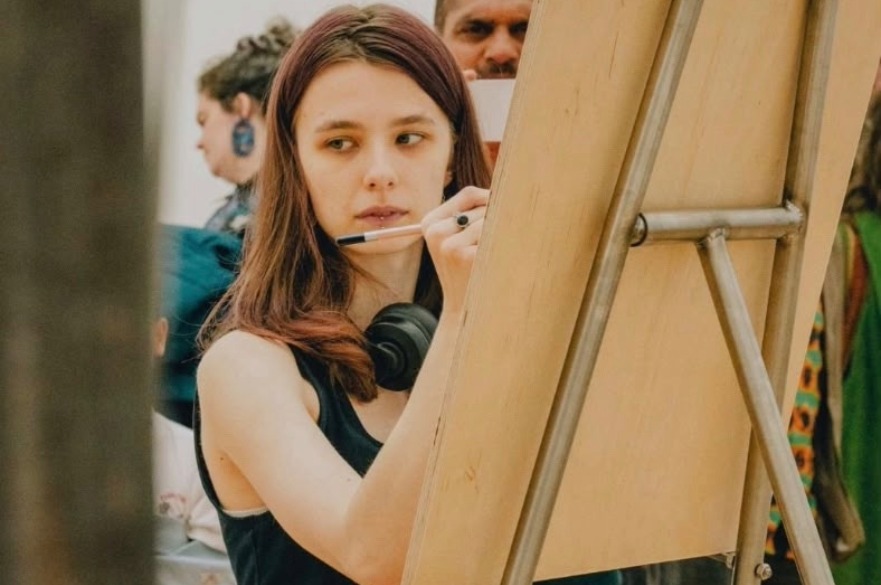 A student drawing on a canvas