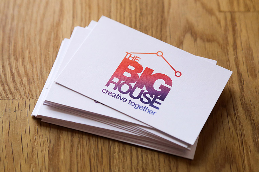 Pile of cards with the big house creative together written on them