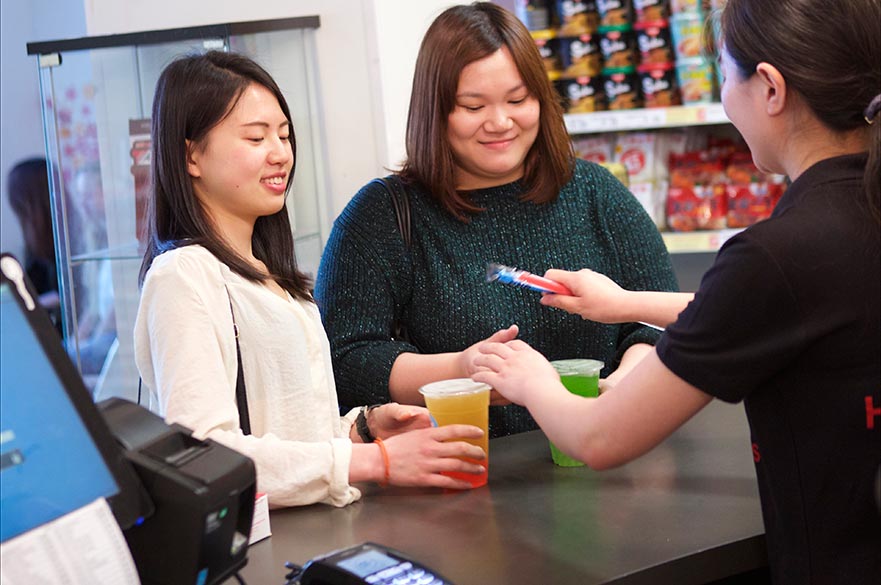 Two students purchasing drinks