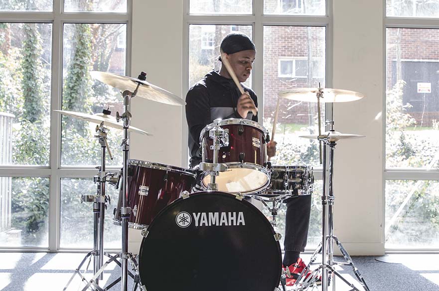 Male student playing drums
