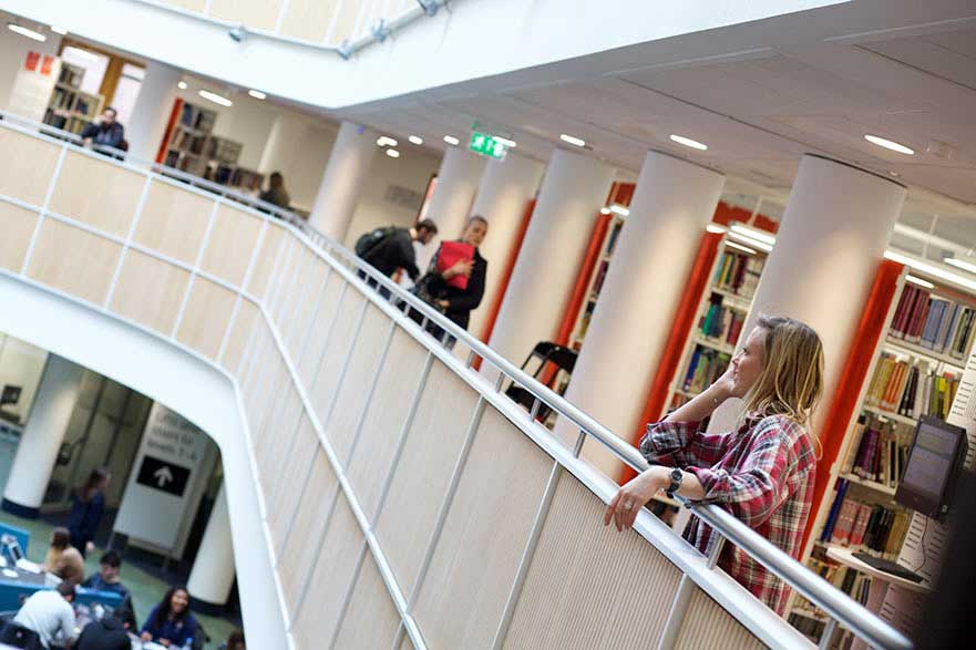 A student on her phone in Boots Library