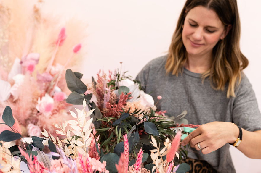 Sarah Ogden with wedding flower arrangement