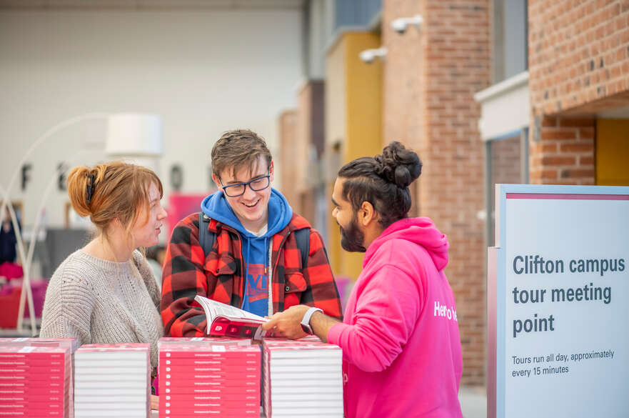 People speaking to an ambassador at an open event