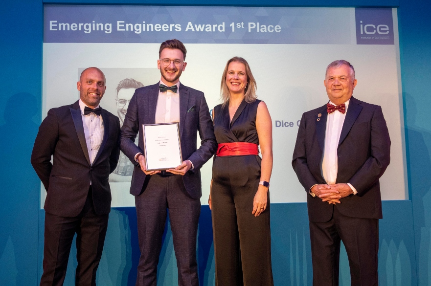 Student on stage holding award
