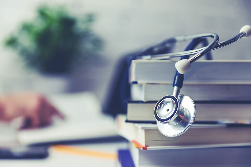 Stack of books with a stethoscope on top
