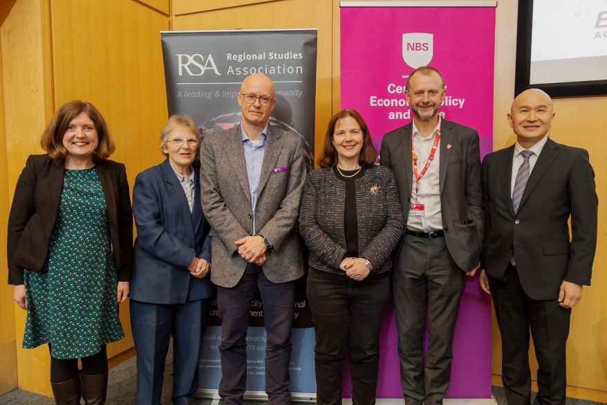Group photo in front of RSA and Centre promotional banners