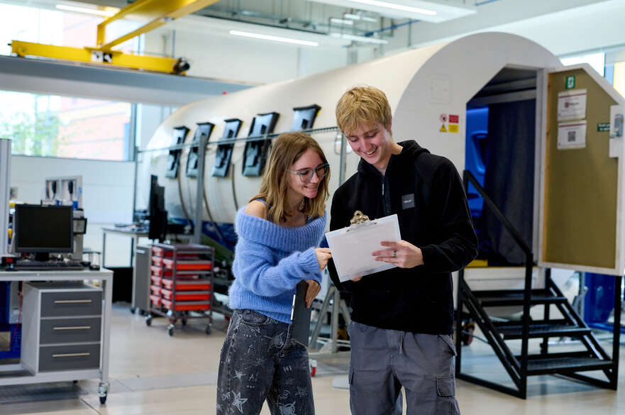 Students in the Aircraft lab next to the flight simulator