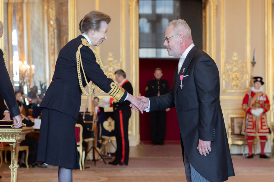 Kevin Osbon shaking hands with The Princess Royal at his investiture.