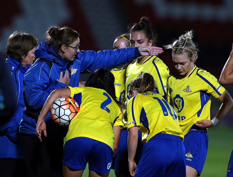 Women's football group huddle