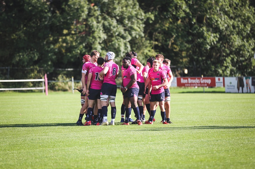 Several NTU Men's Rugby Union Players Huddle Around