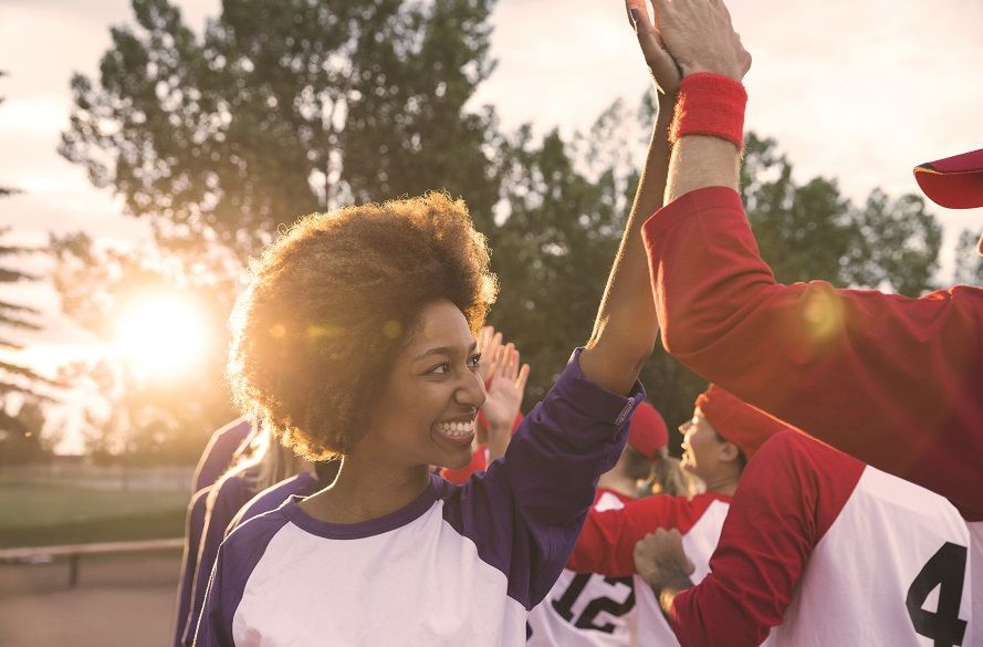 Photo of female high fiving a team mate.