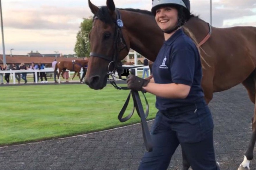 Student walking with horse