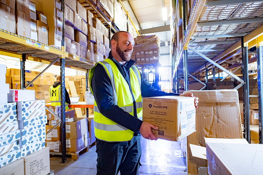 Man holding a box in a warehouse