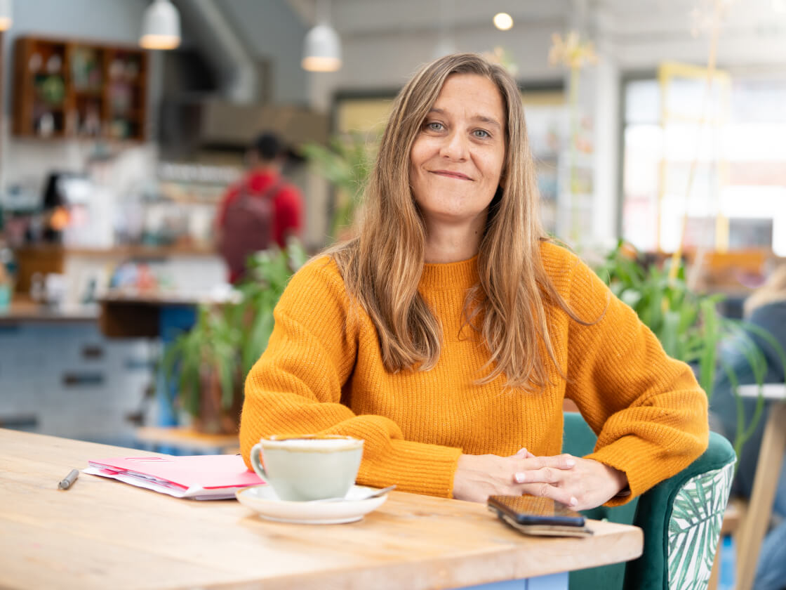 Woman sitting at table smiling