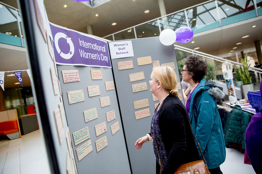 International Women's Day event with statements on a board