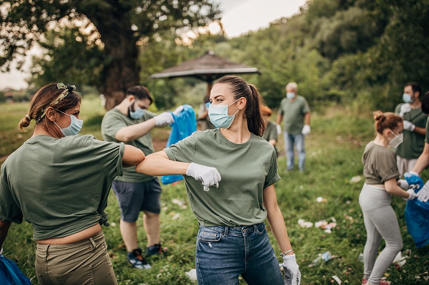 Young people in masks picking up litter