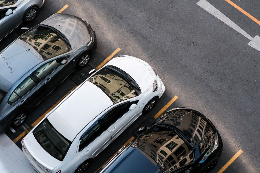 Three cars parked in car parking spaces