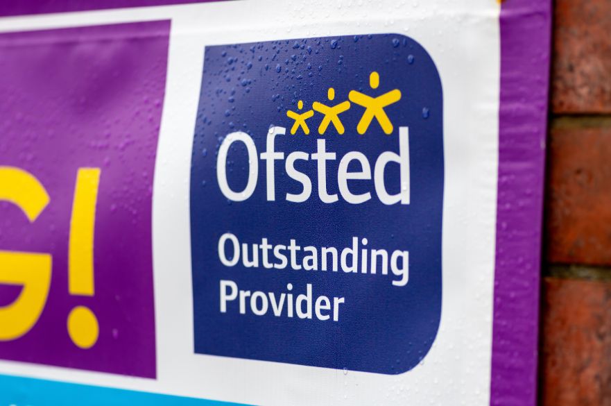 Ofsted rated outstanding banner on a wall