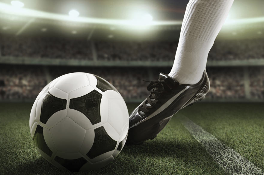Football boot kicking football